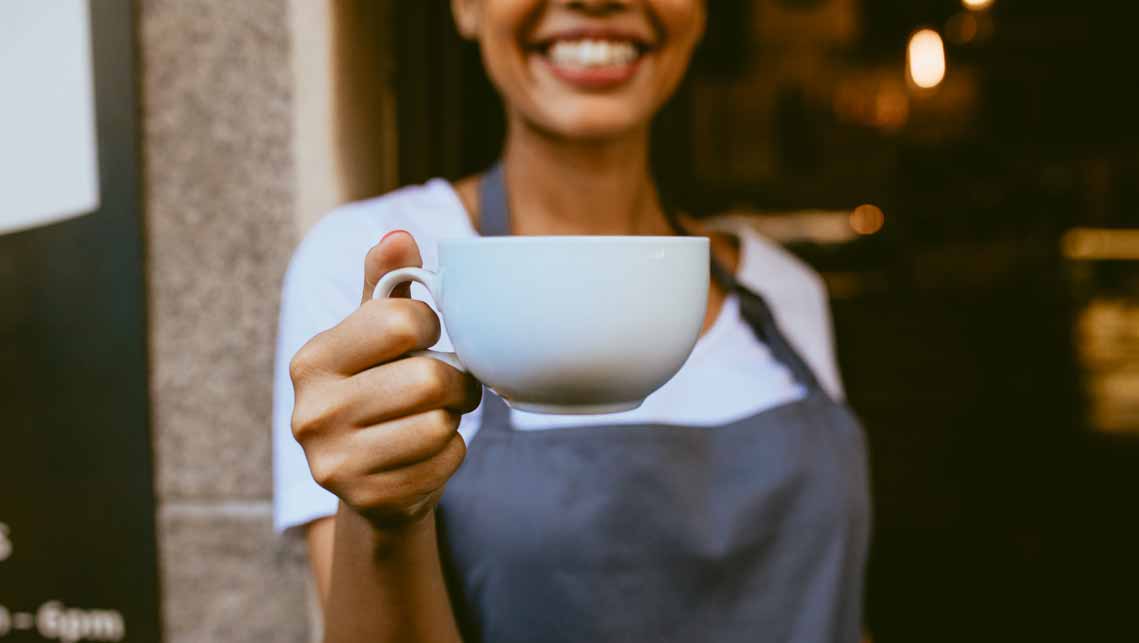 woman holding cup of coffee 4th wave of coffee